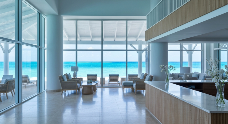 Elegant lobby of a luxury Caribbean resort overlooking clear blue ocean